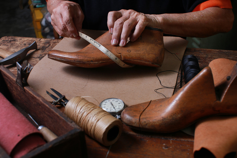 Shoemaker workshop with tools, shoes and laces